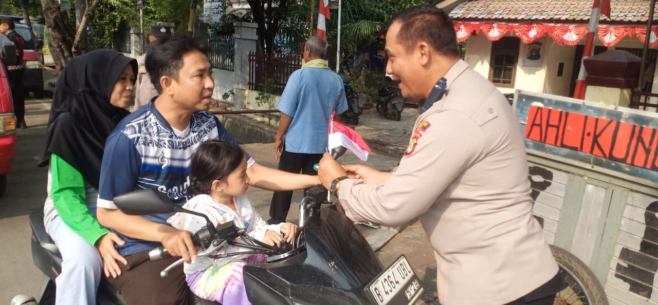 Polsek Koja Bagikan 100 Bendera Merah Putih Kecil kepada Pengendara di Jl. Kramat Jaya